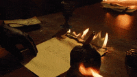 gif: hand writing on a burning paper