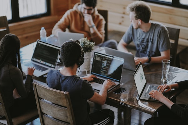 A team of developers working together at their laptops