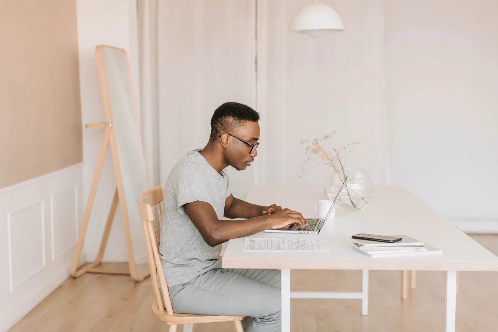 Man working on a computer in a cozy space