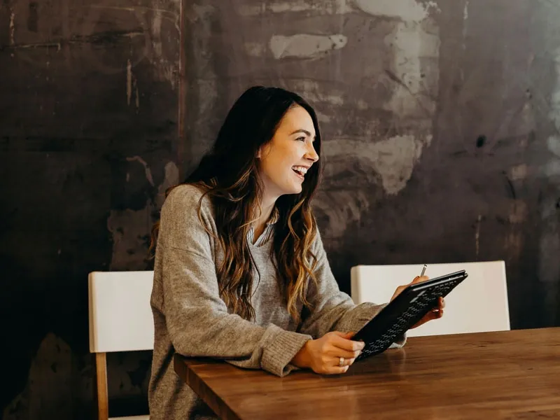 Woman smiling with a tablet in her hands